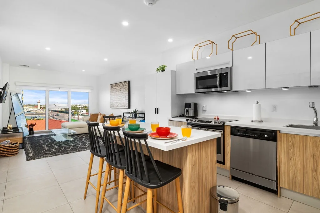 Step into a bright, open space where you can whip up meals in a modern kitchen, relax in the stylish living area, and enjoy views of the surrounding area through large windows.