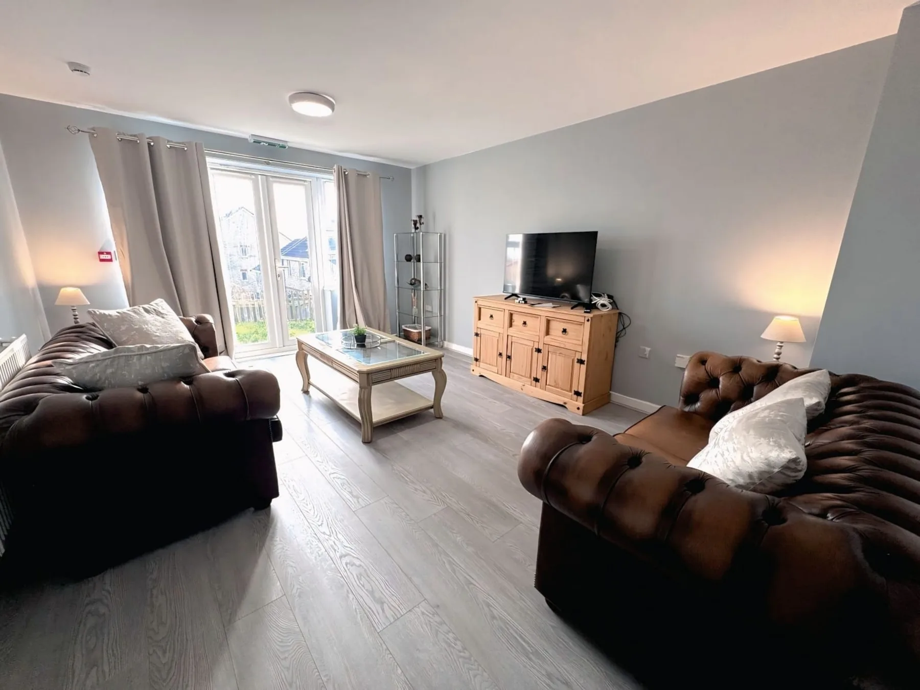 A living room with two sofas, a coffee table, and a television.