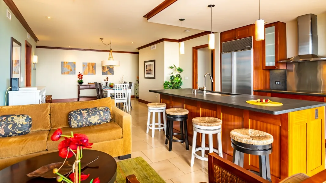 An open-plan living room and kitchen with a breakfast bar and seating.