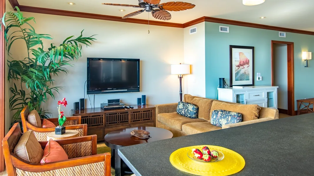 A living room with seating, a television, and a coffee table.