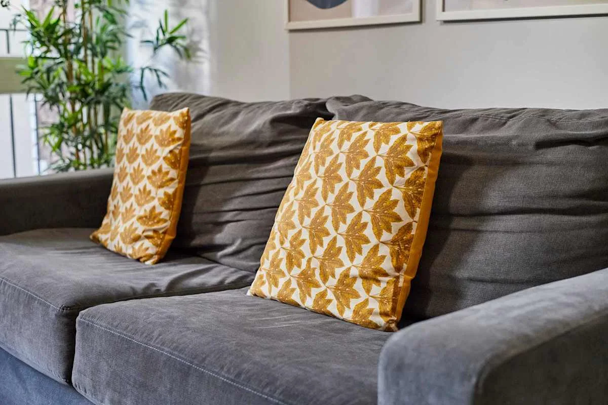 A living room seating area with patterned cushions on a gray sofa.