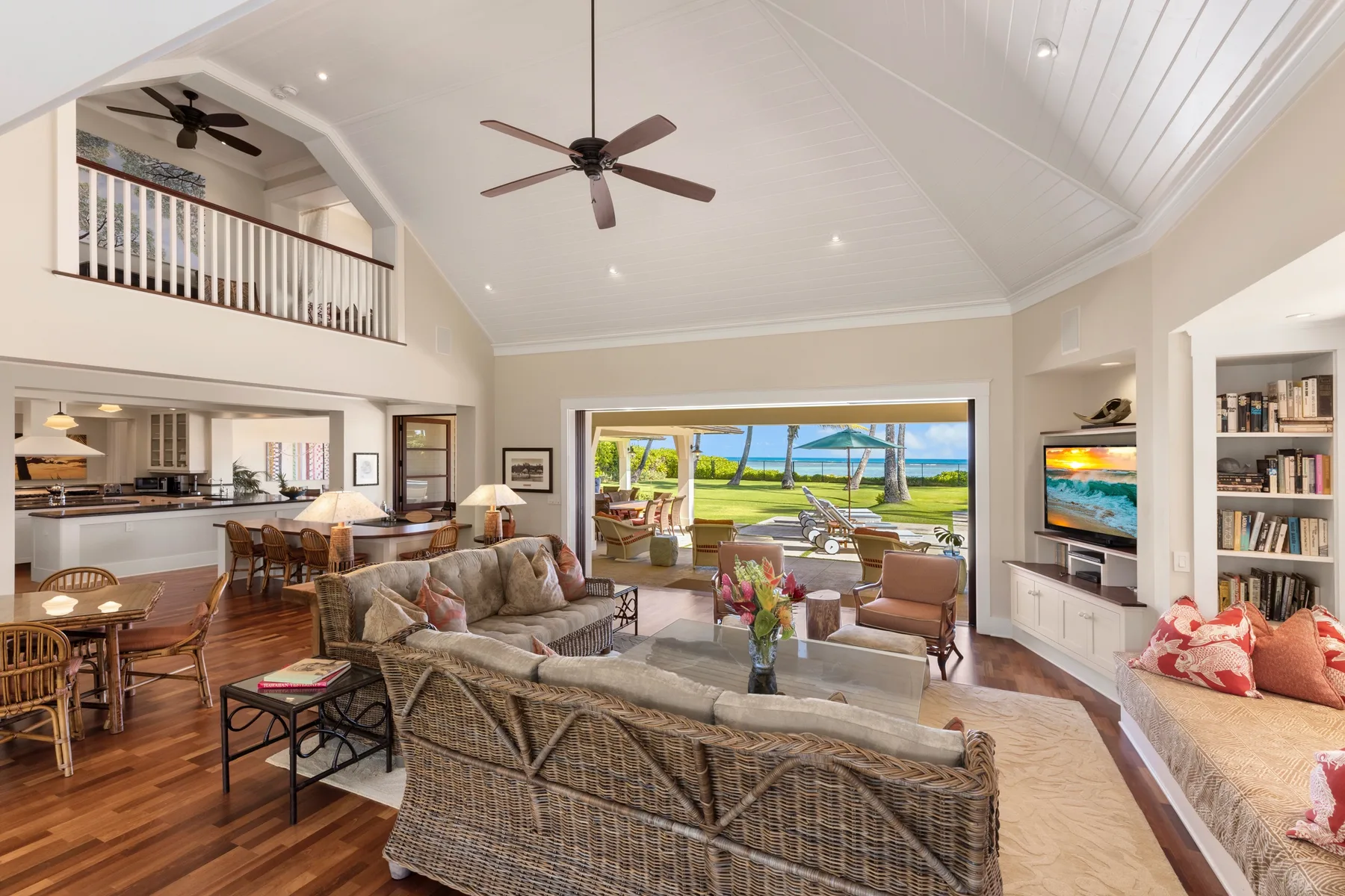 A spacious living and dining area opens onto a patio overlooking the water.