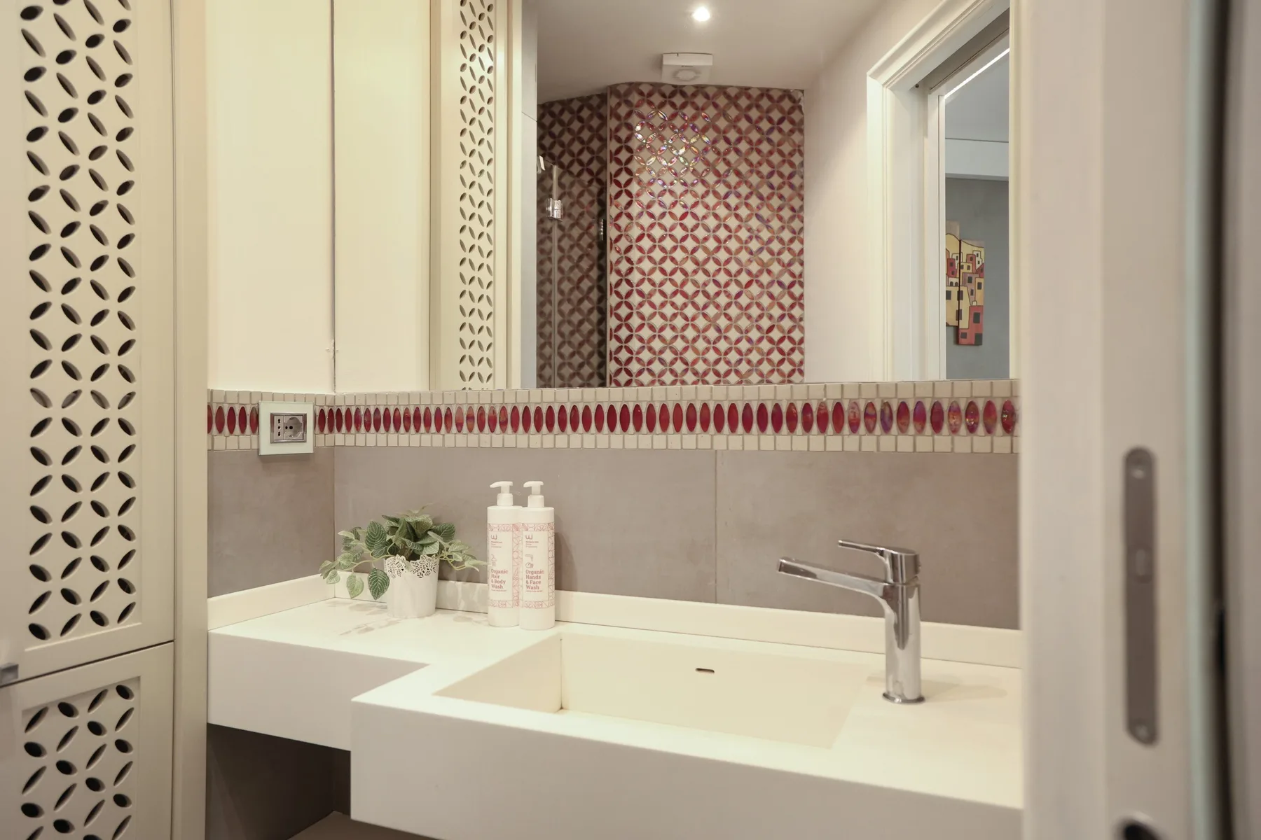 A bathroom vanity with a wide sink and a wall mirror.