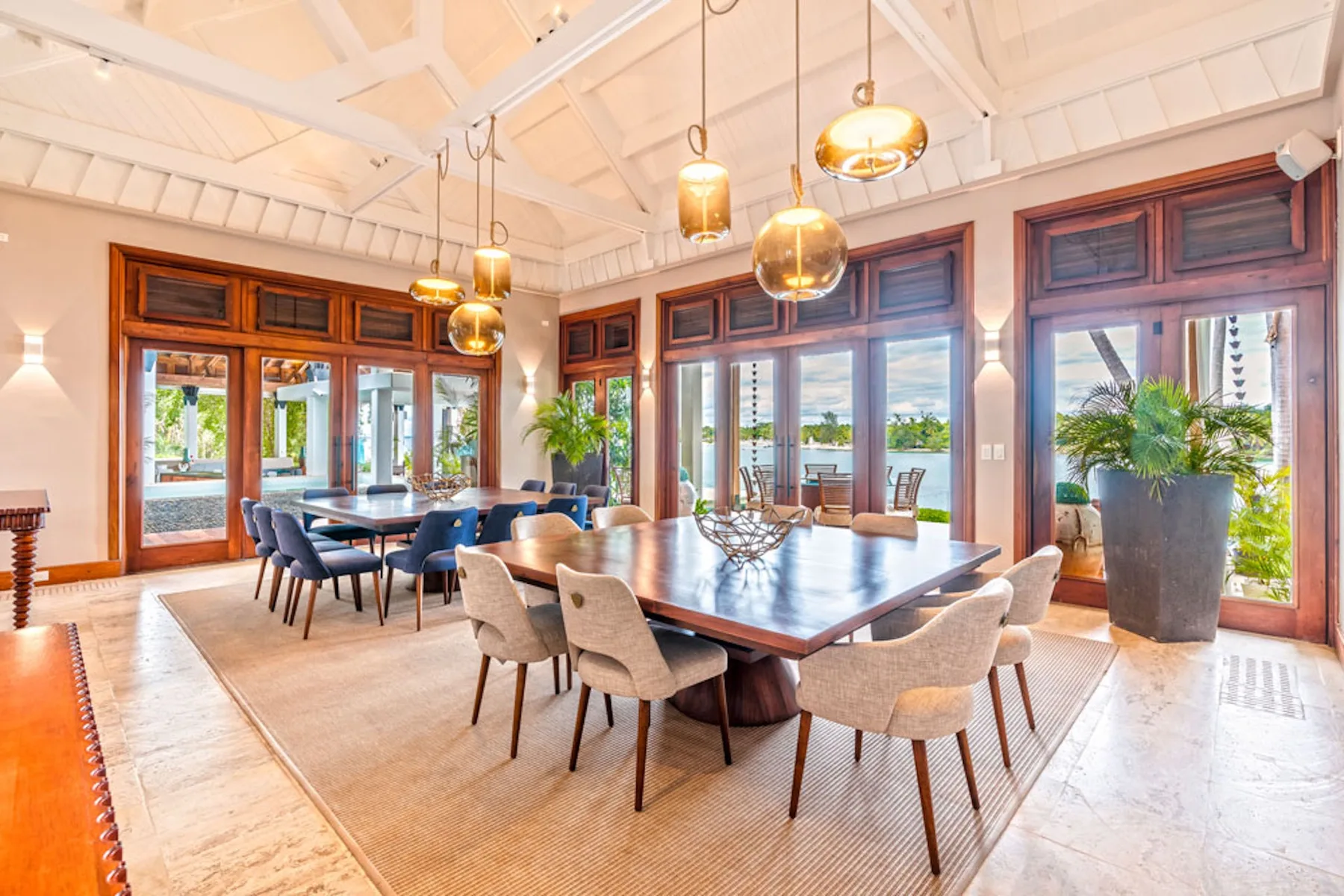 A bright dining room with tables, seating, and large windows.
