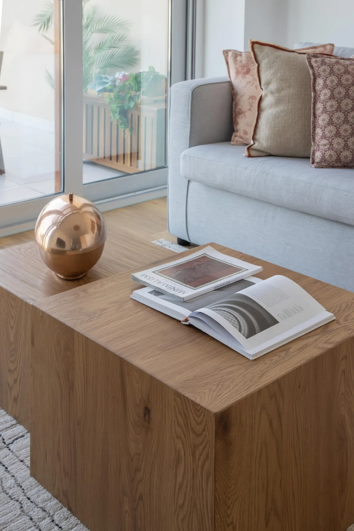 A living room seating area with a wooden coffee table and open books.