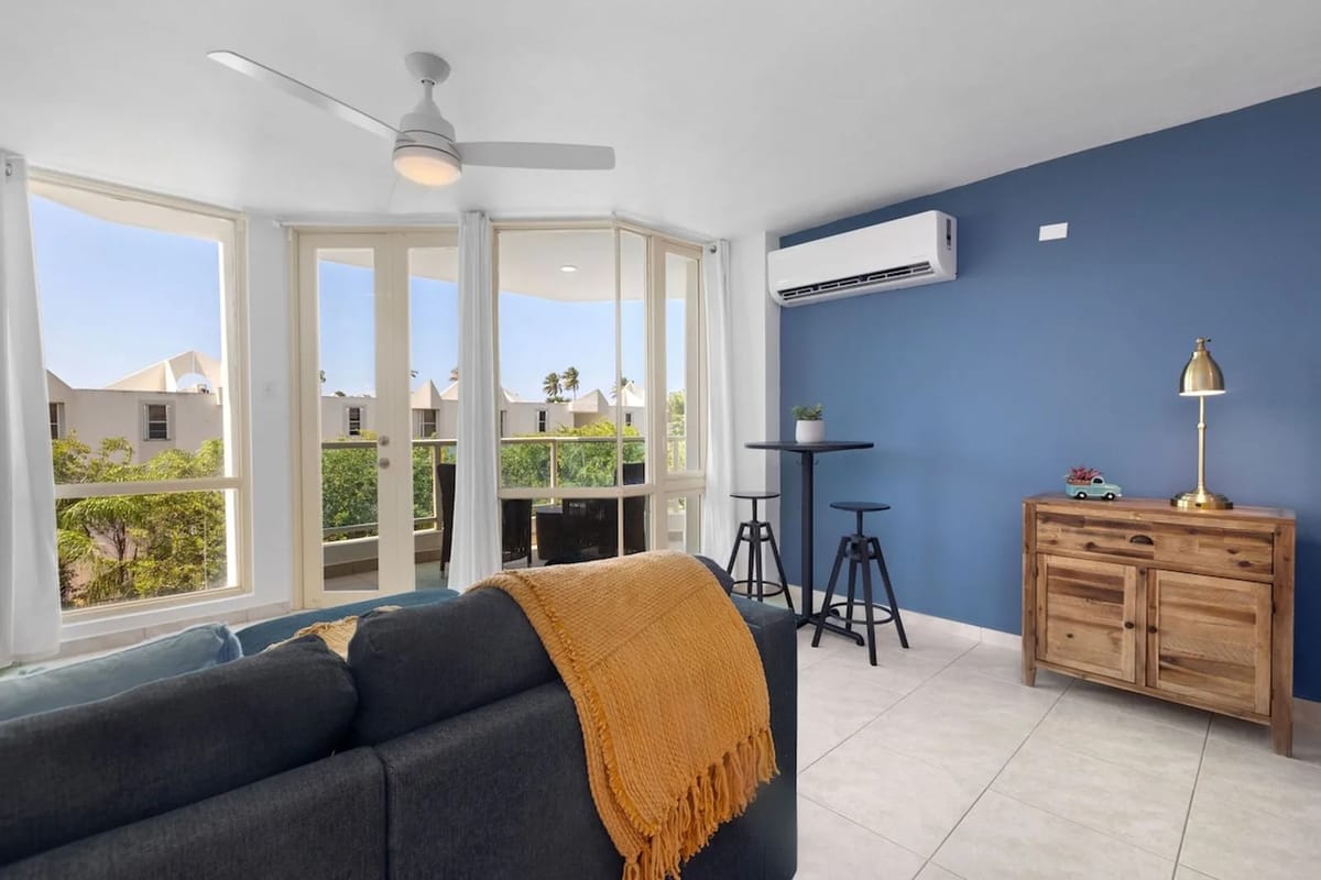 Living room extending to a private balcony with views.