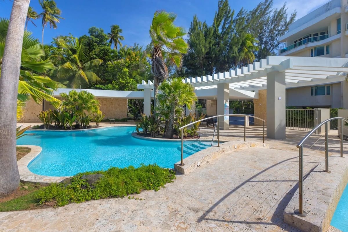 Pool surrounded by tropical landscaping.