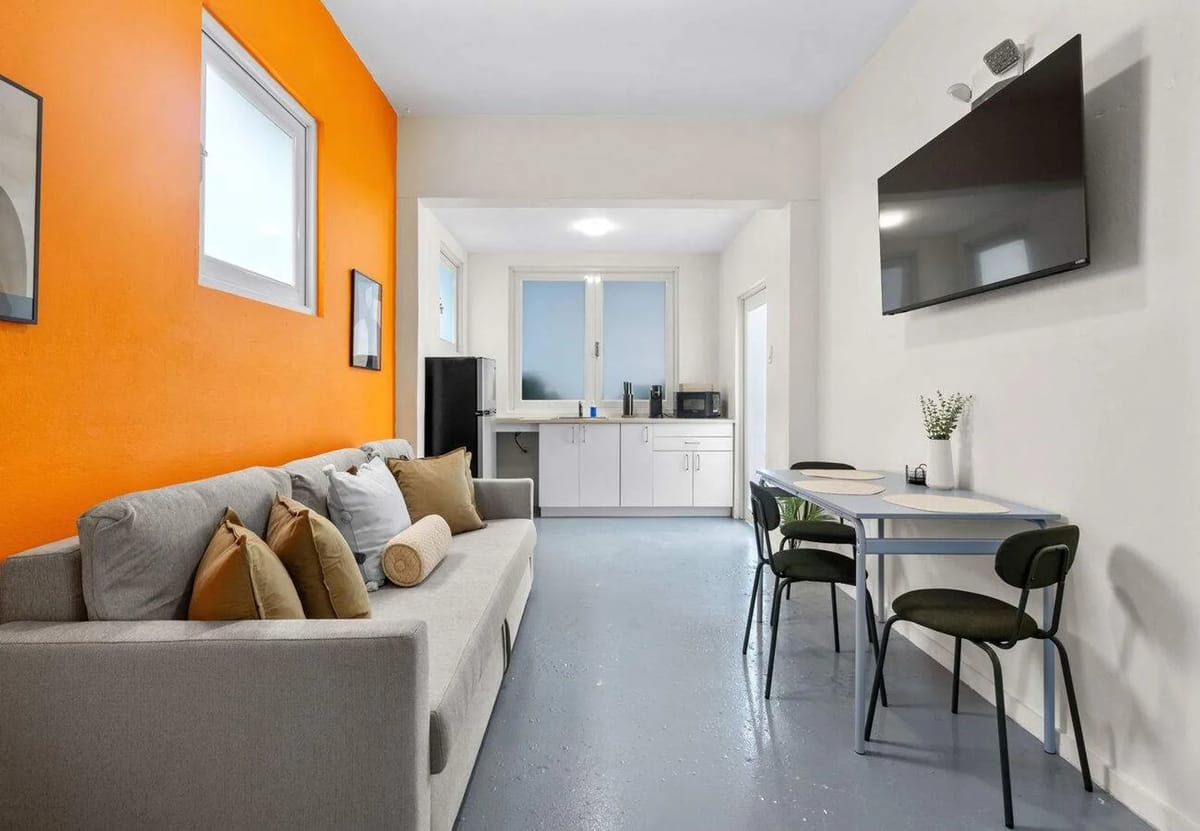 Bright Condado living room with sofa bed, smart TV & kitchen