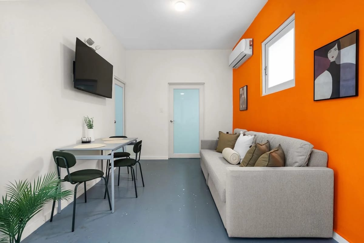 Colorful living area with sofa bed and dining nook