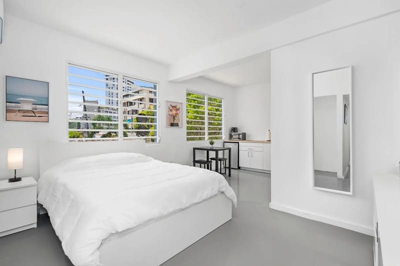Large windows bring natural light into the studio and frame outdoor views.